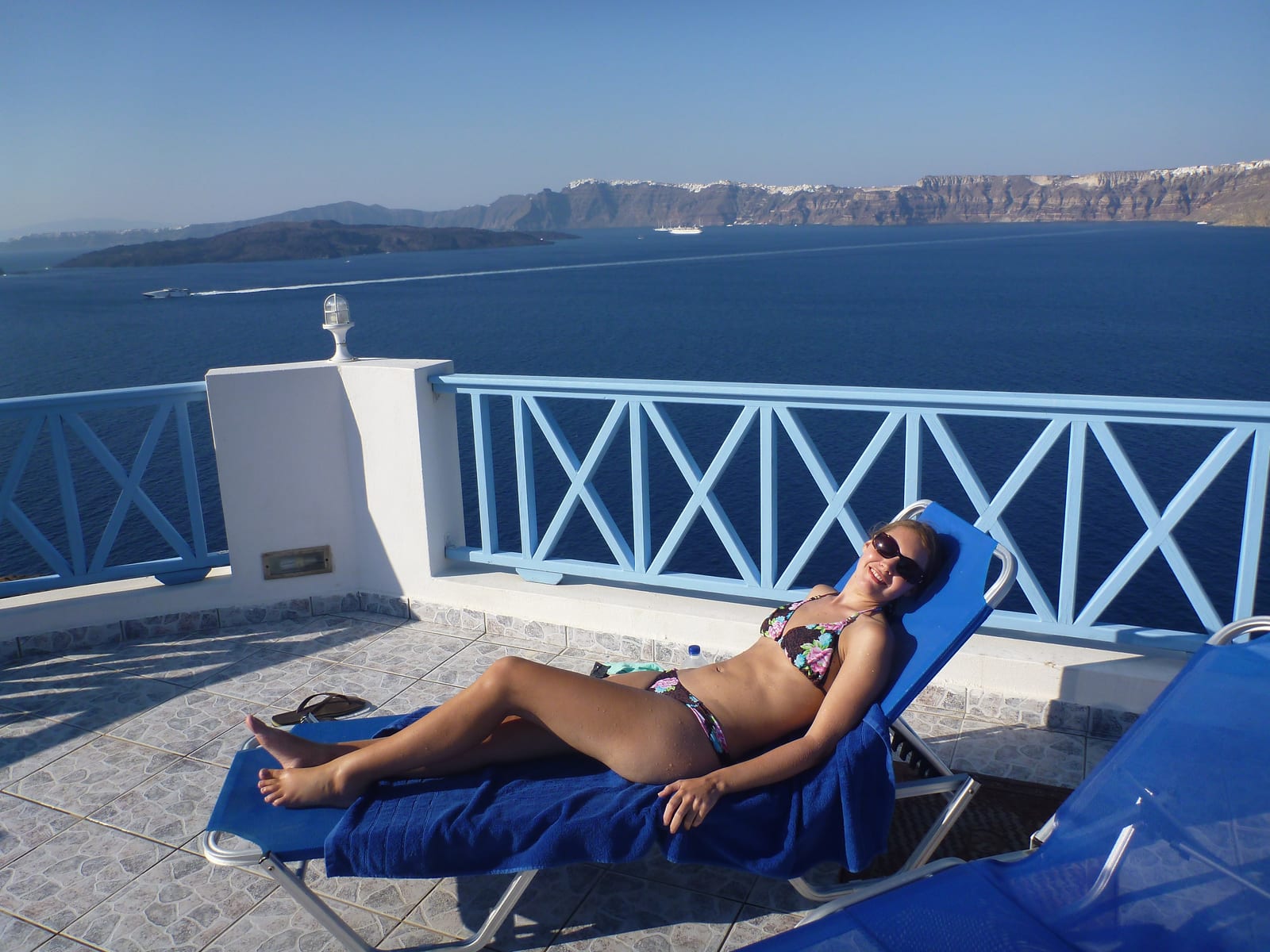 Sun lounger and caldera view at Blu Rooms, Santorini, Greece