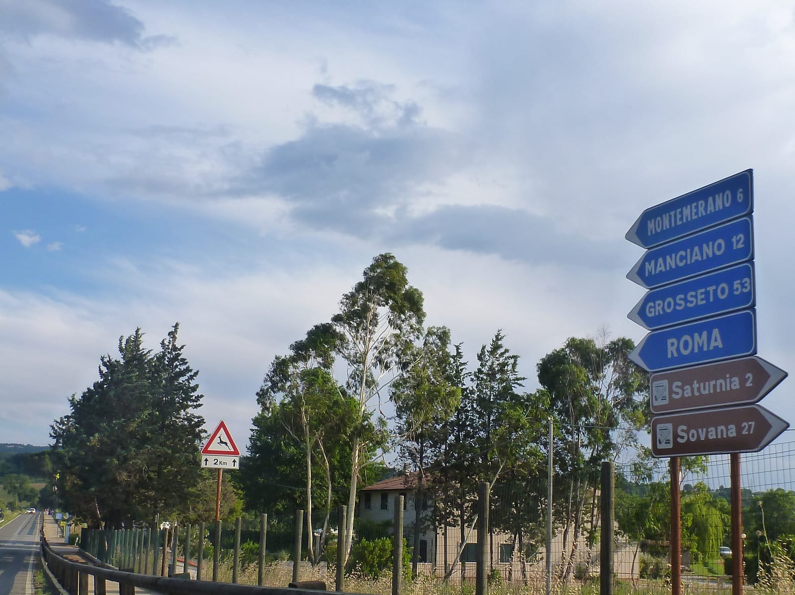 Road sign pointing to Saturnia on the drive through Tuscany, Italy