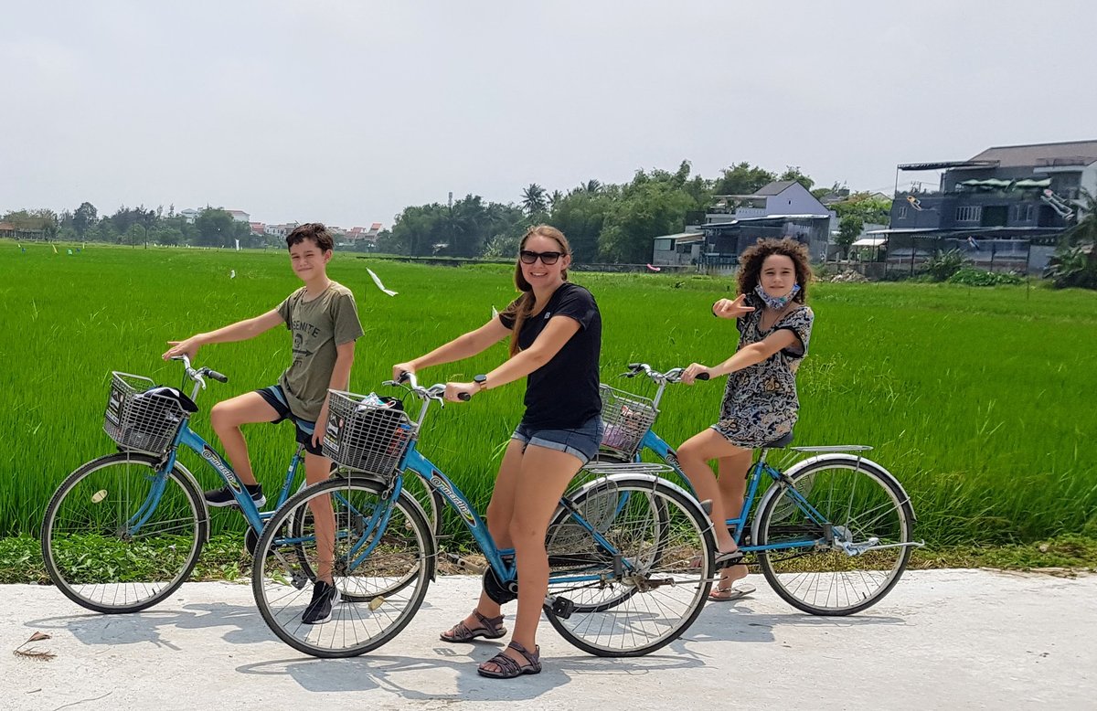 Family cycling through rice fields in Hoi An during Covid-19 - World Travel Ambitions