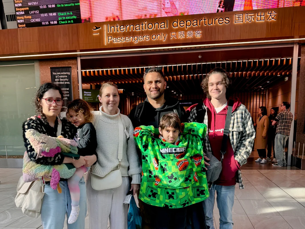 Family departing New Zealand September 2024 at international departures airport terminal - ready for next worldschooling adventure