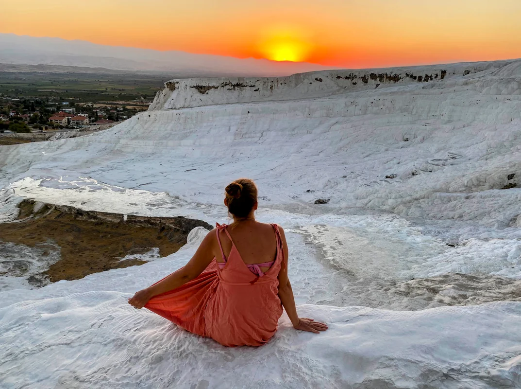 Pamukkale sunset with woman on white travertine terraces, Turkey - World Travel Ambitions
