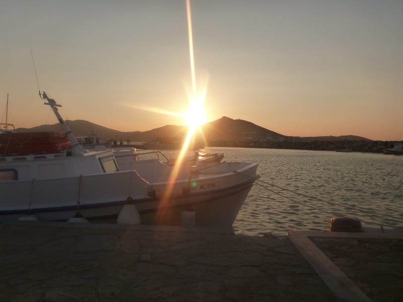 Boat at sunset in a harbour on Paros, Greece
