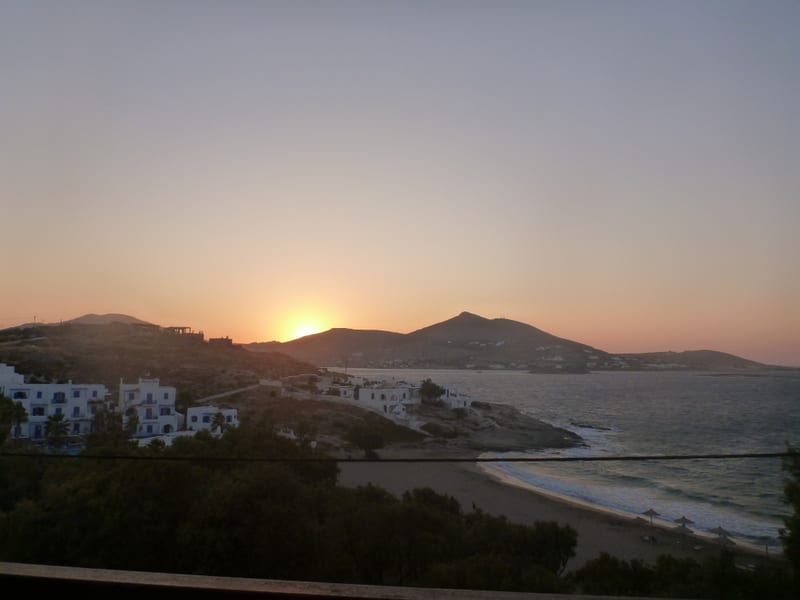 Sunset over the beach and whitewashed houses on Paros, Greece