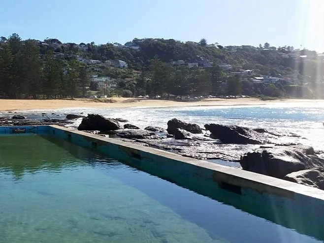 Whale Beach Sydney Northern Beaches - Ocean pool with clear blue water and darker sand beach for families