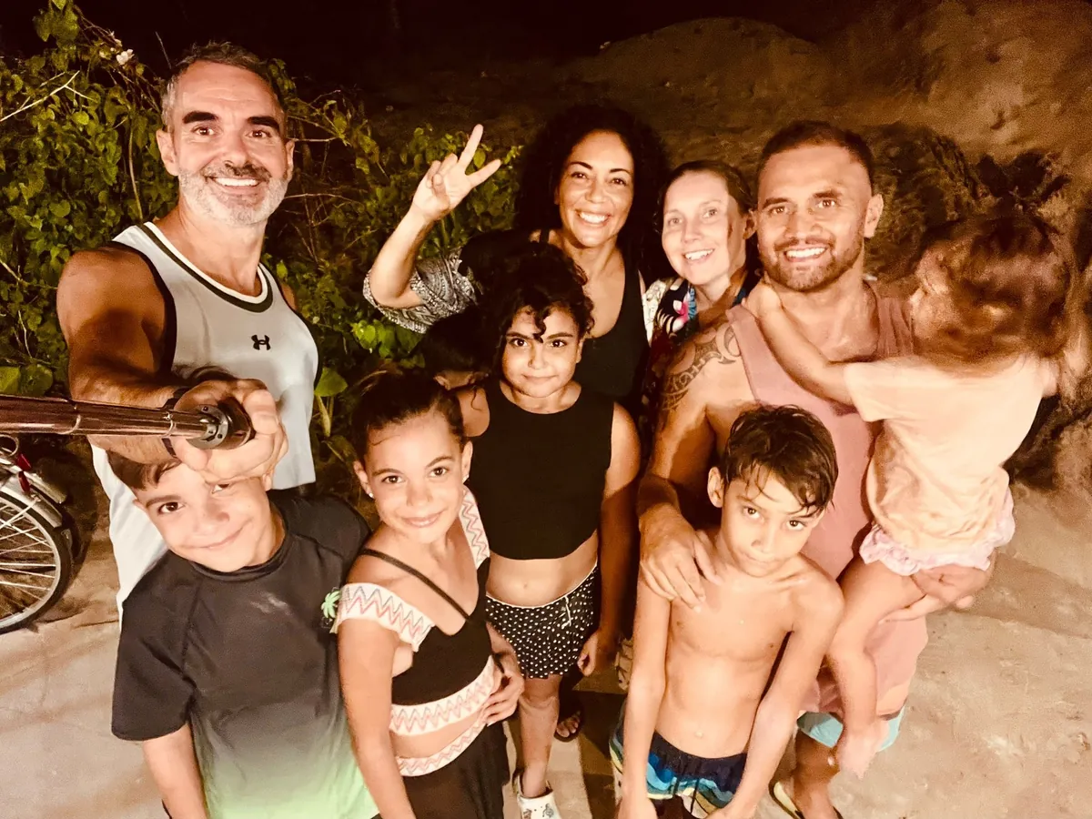 Worldschooling families community in Hoi An Vietnam 2025 - group of parents and children enjoying evening together showing the strong community bonds