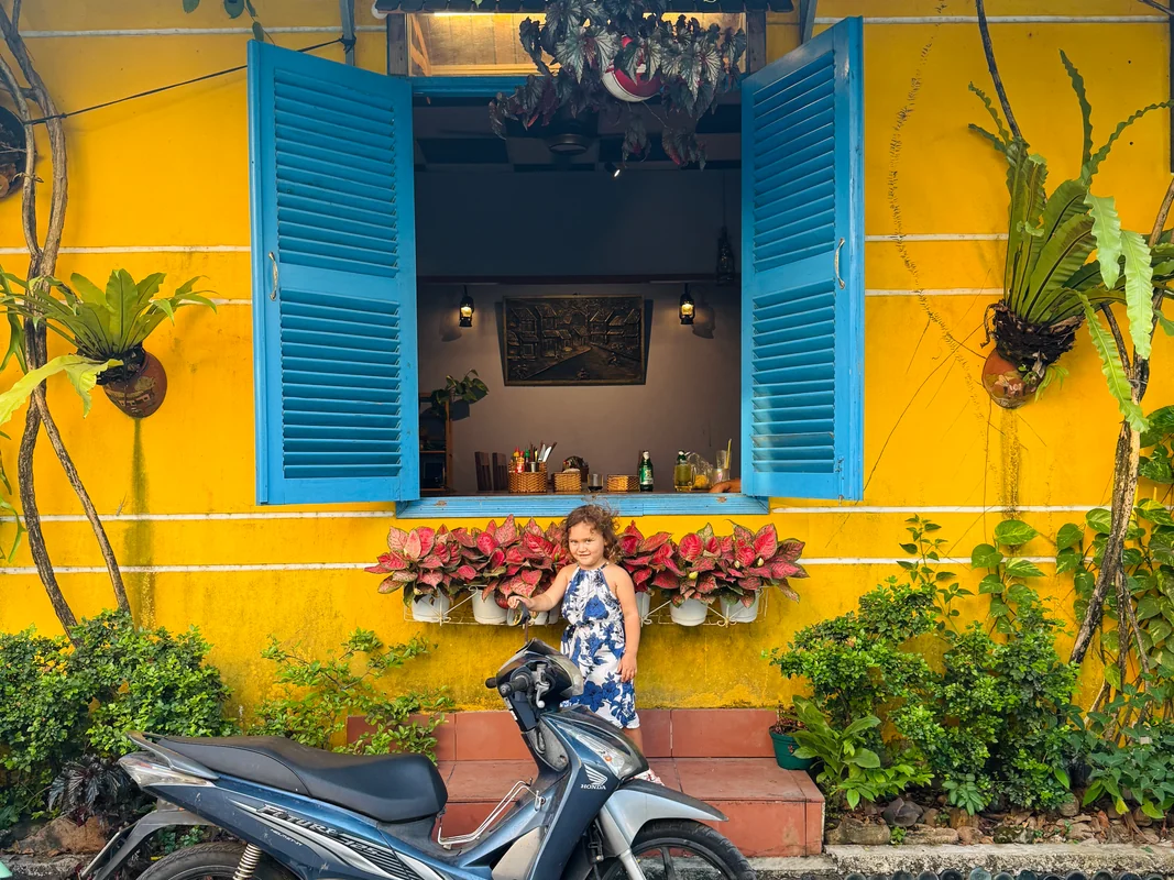 Worldschooling on Phu Quoc Vietnam 2025 - Young girl in front of colorful tropical building